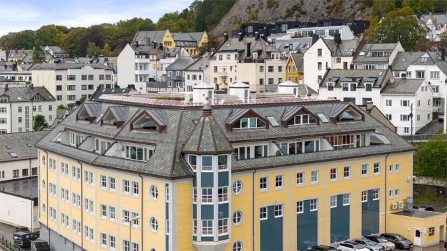 Bygget ligger sentralt til like øst for Ålesund bysentrum, med Byparken og Aksla i bakkant.