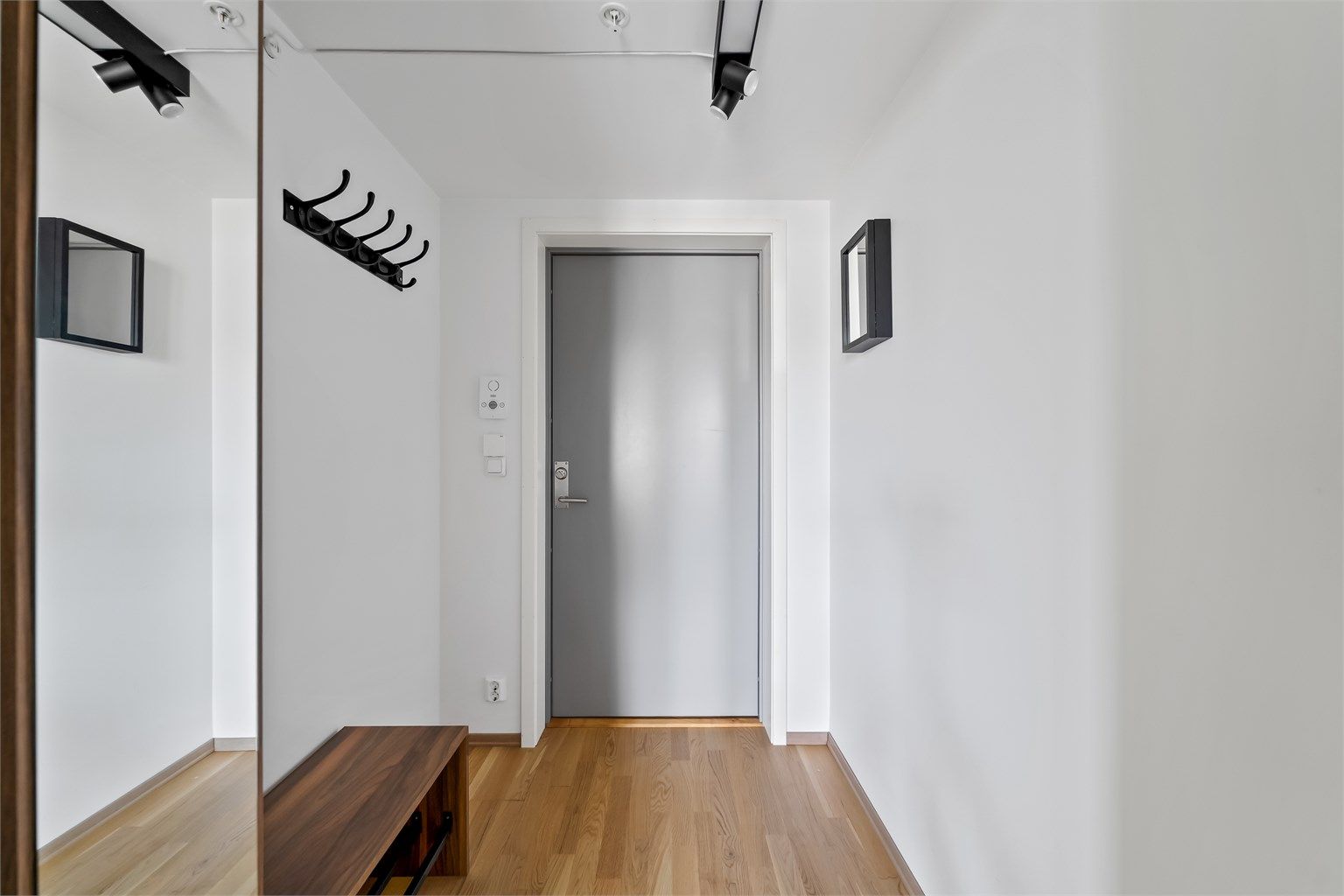 Entreen er lys og tiltalende, og det er god plass til kles - hengløsninger. Det er skyvedørsgarderobe i gangen innenfor, og videre adkomst til stue/kjøkken, 2 soverom, bad og bod.