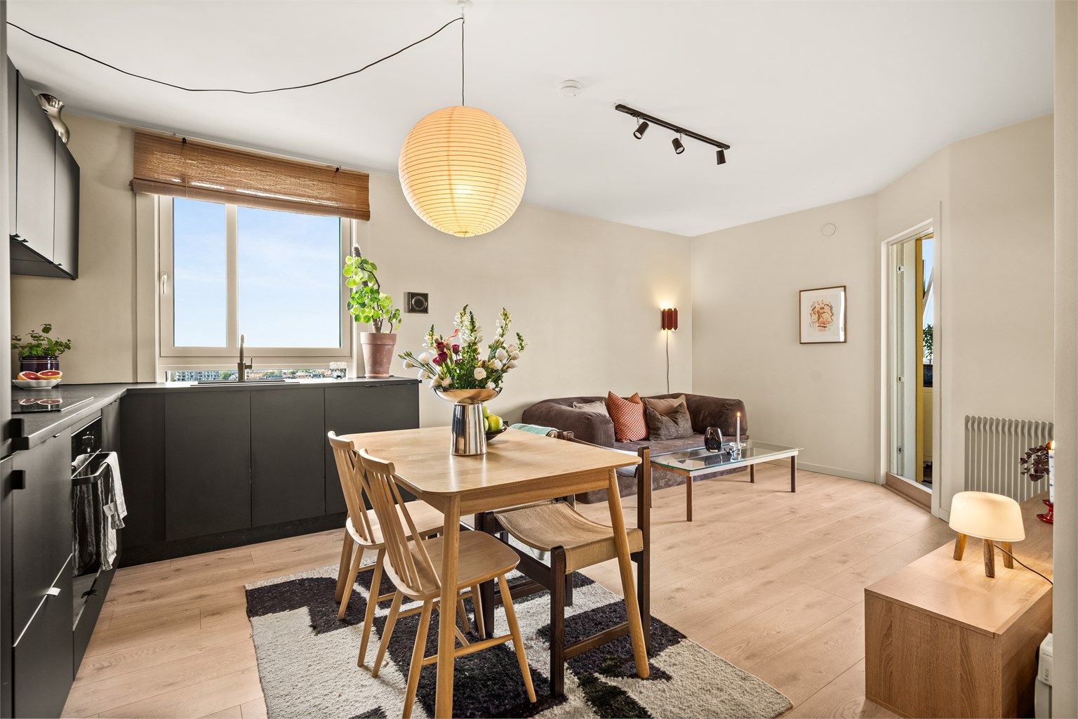 Leiligheten har et moderne HTH-kjøkken fra 2021 i åpen løsning mot stuen. Foto: Martine Eren Jacobsen Studio