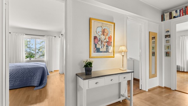 Fra gangen er det adkomst til alle rom. Dørene med glassfelt bidrar til å slippe lyset gjennom leiligheten.