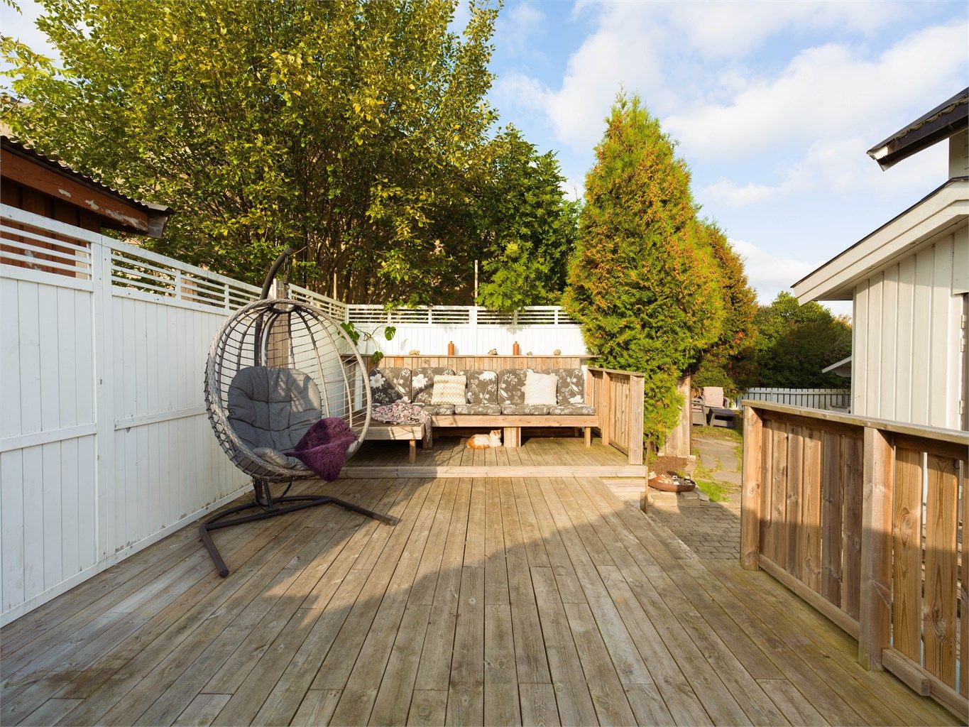 Skjermet terrasse med gode solforhold og plass til flere sittegrupper.