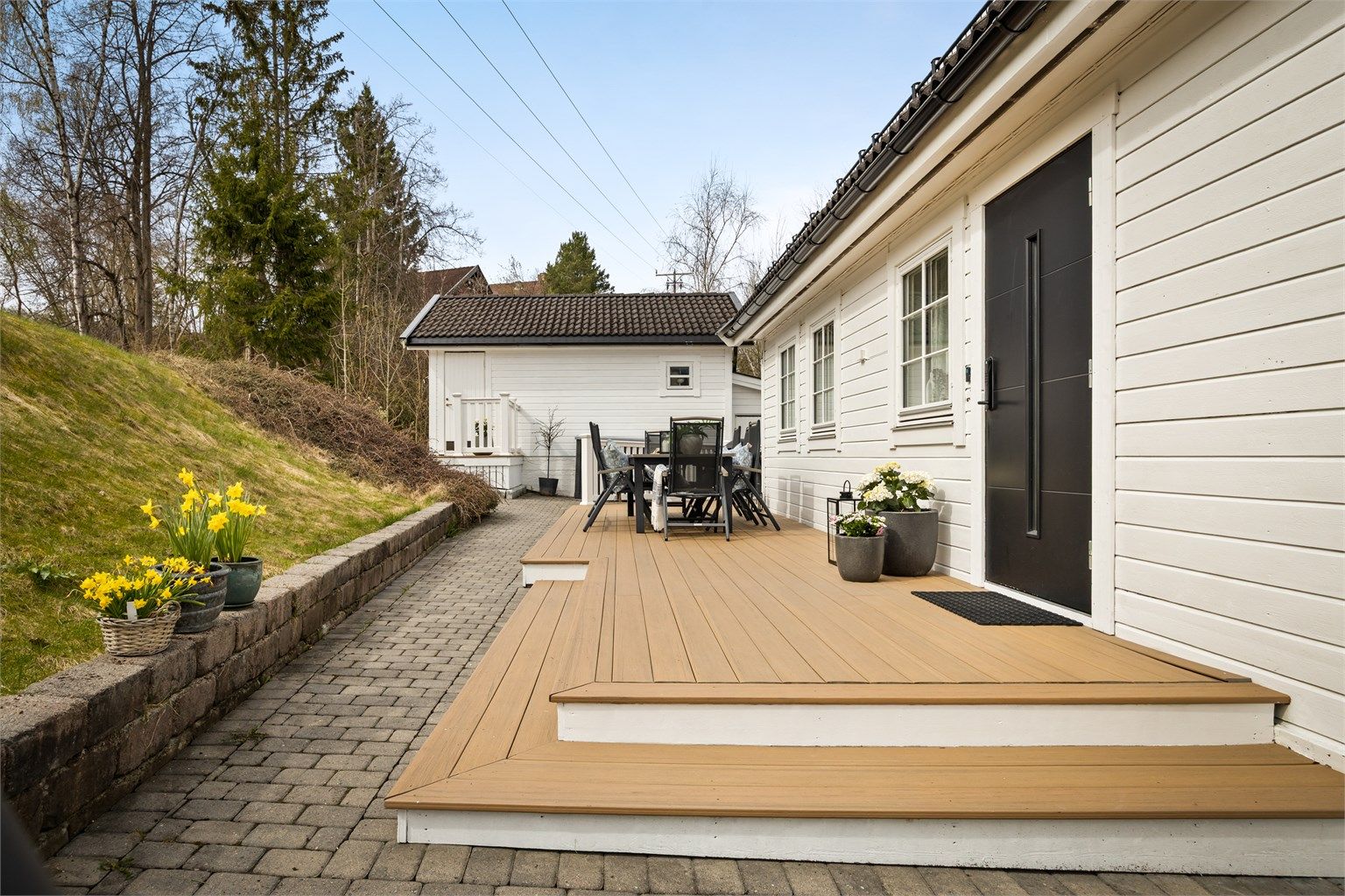 Pent opparbeidet inngangsparti med belegningsstein og trapp opp til terrassen.