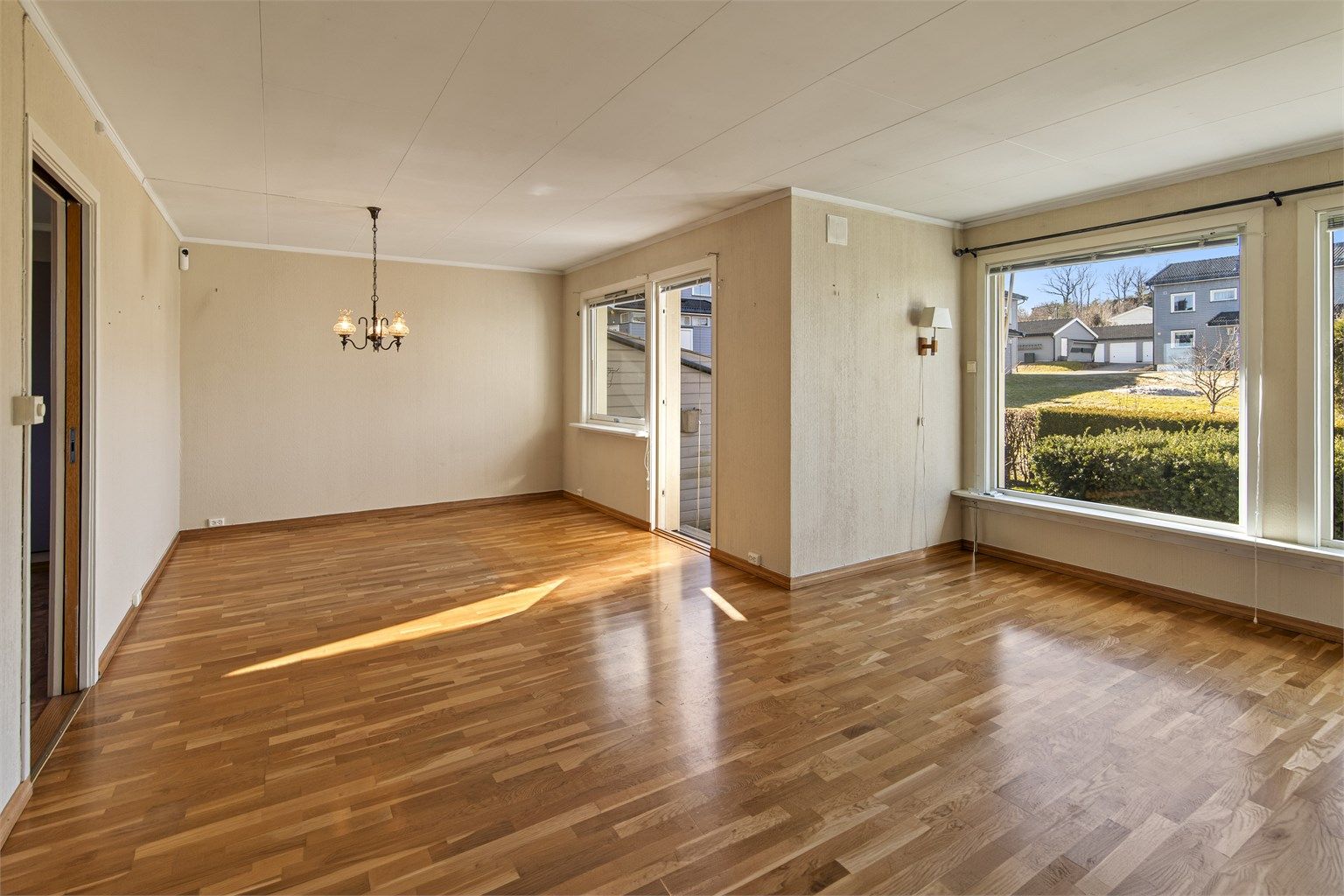 Stuen har god plass til både sittegruppe og spisebord, med eikeparkett på gulvet.