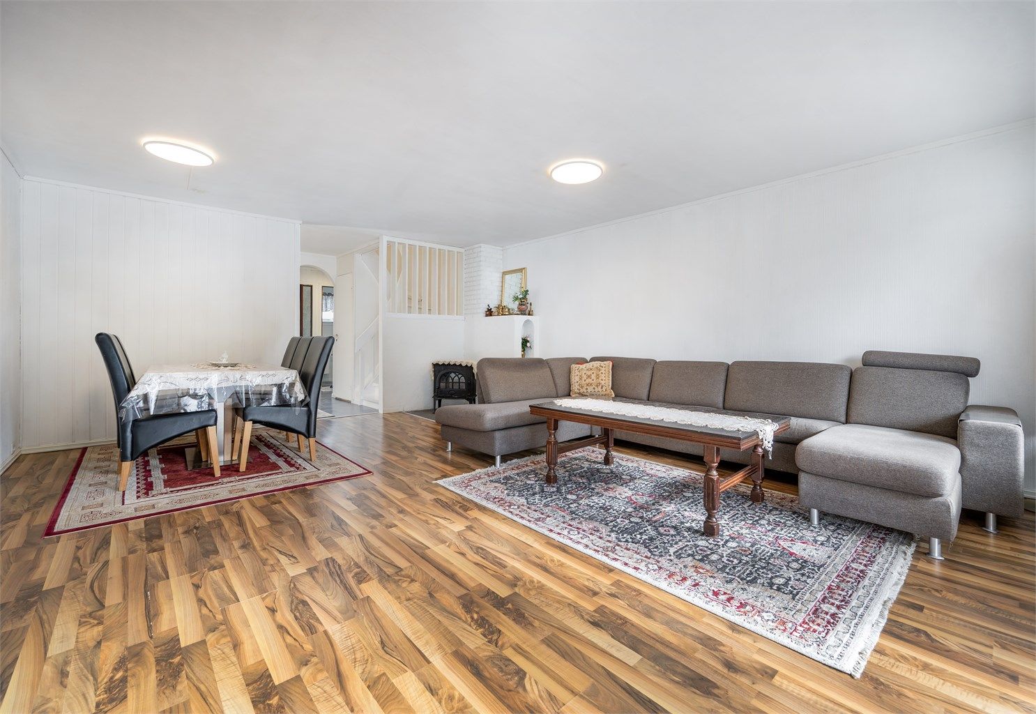 Stuen har god plass til både spisebord og sofagruppe, samt et ildsted for ekstra varme.