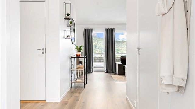 Gjennomgående laminatgulv og vannbåren gulvvarme skaper en lun og behagelig atmosfære fra entréen og videre inn i stuen.