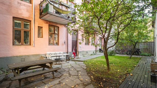 Den grønne bakgården byr på hyggelige sitteplasser og en rolig atmosfære.