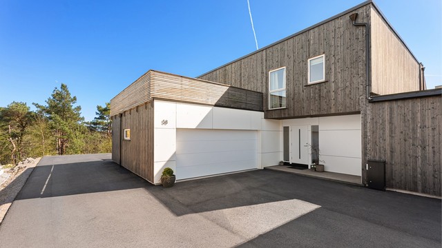 Stor gårdsplass med dobbel garasje og plass bak garasje til båt, bil eller bobil eller det man måtte ønske