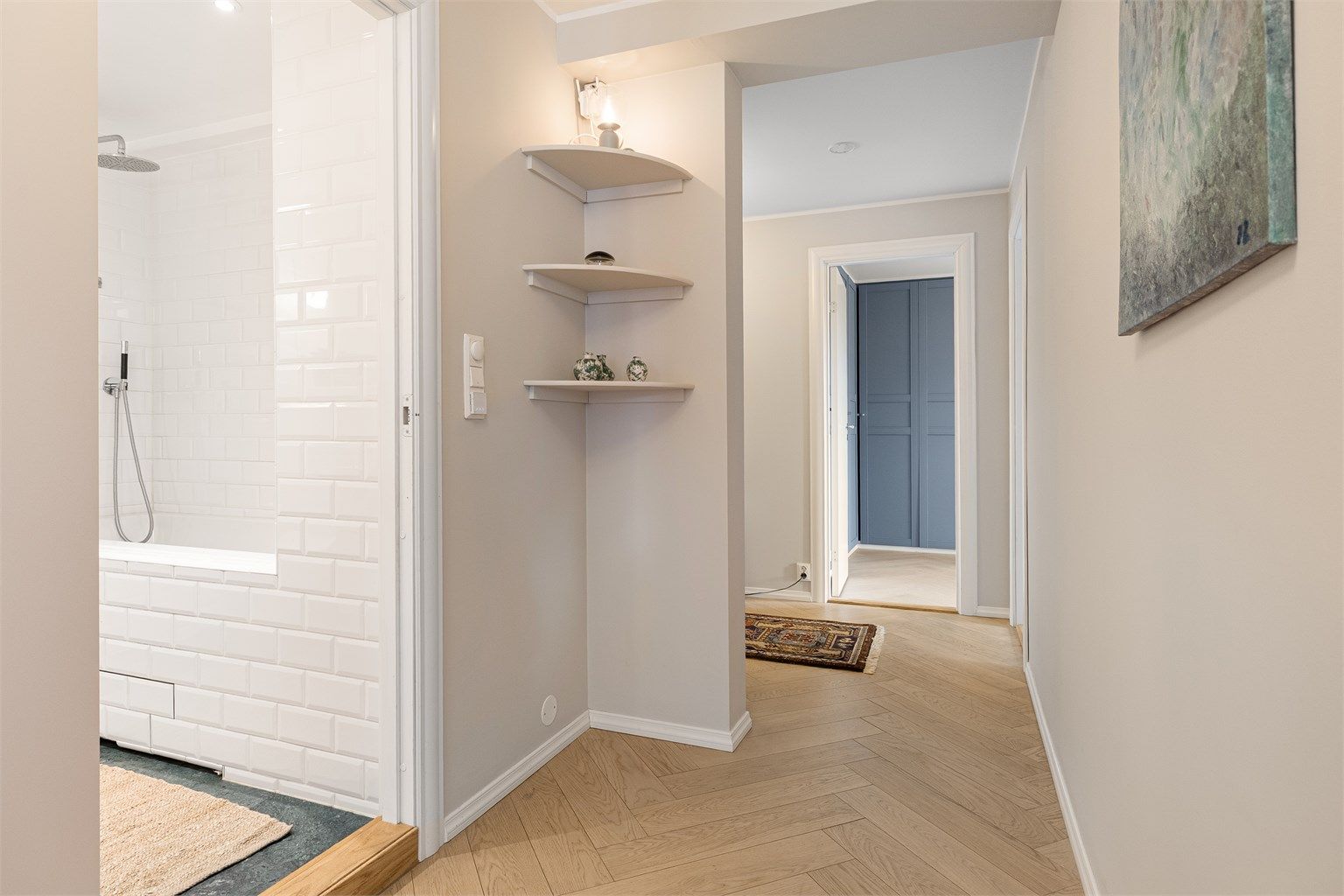 Små detaljer som de innebygde hjørnehyllene bidrar til leilighetens sjarme og funksjonalitet.