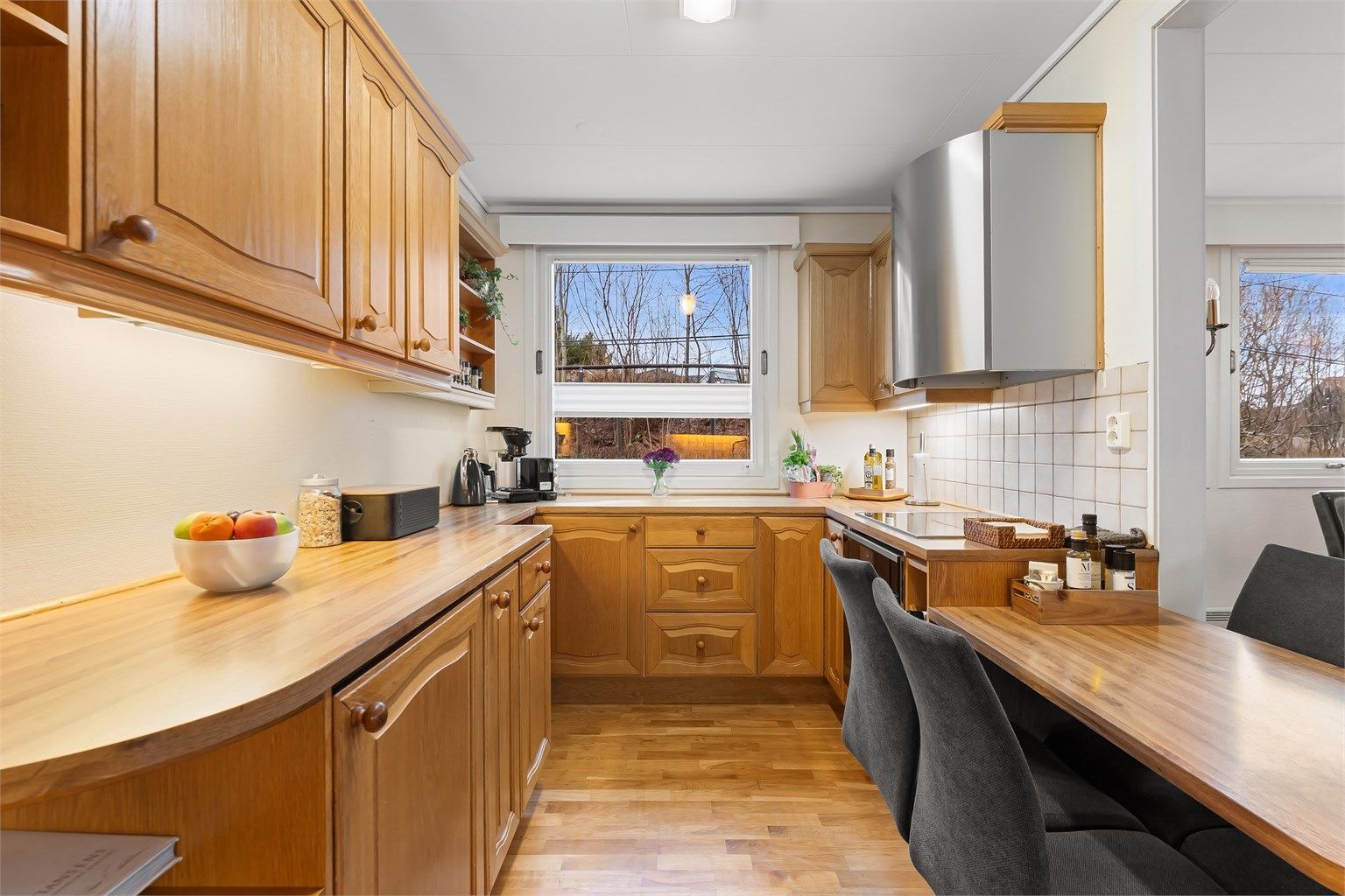 God arbeidsflate på benkeplater av tre og laminat, med belysning under overskapene.