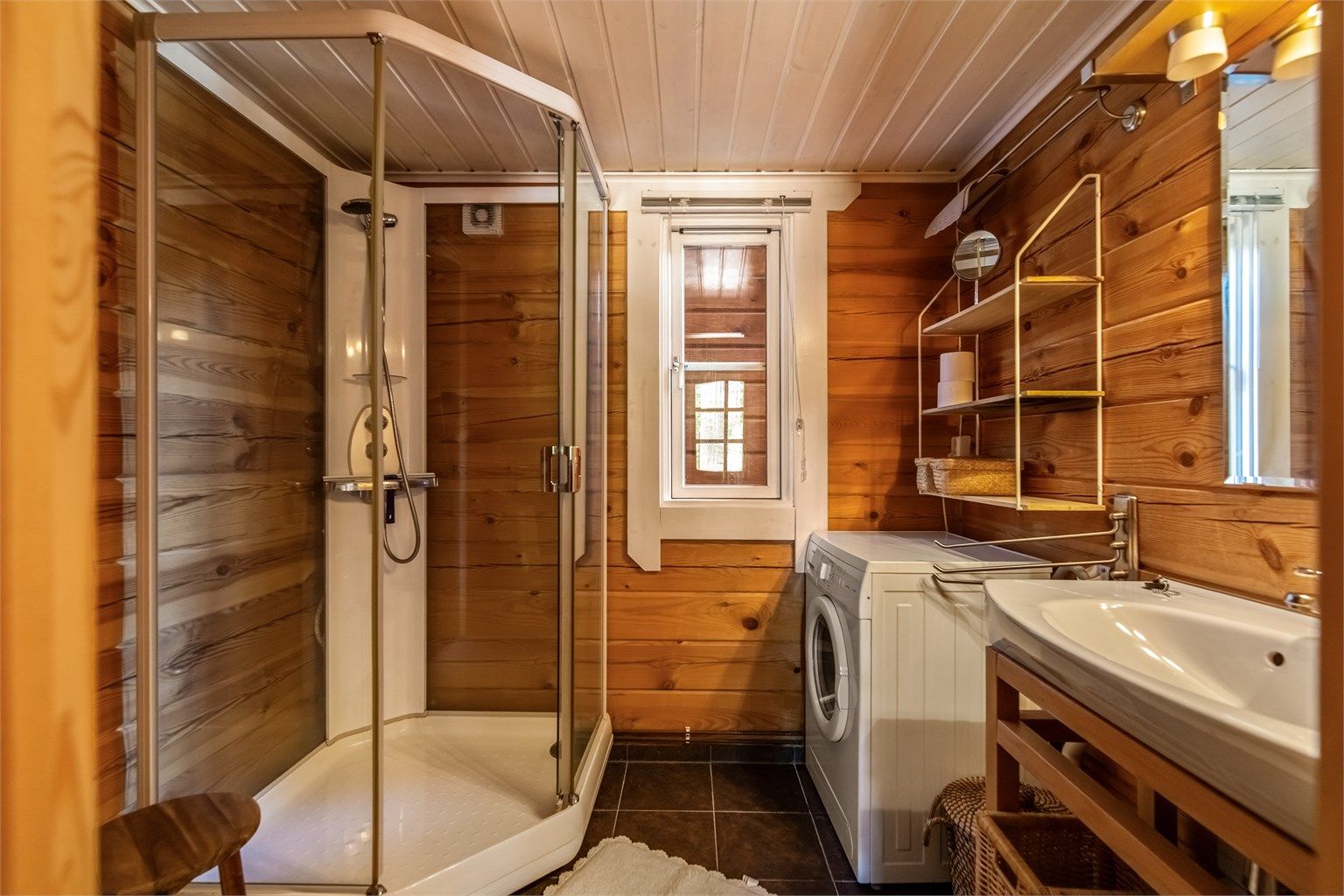 Badet er utstyrt med dusjkabinett, toalett og har opplegg for vaskemaskin.