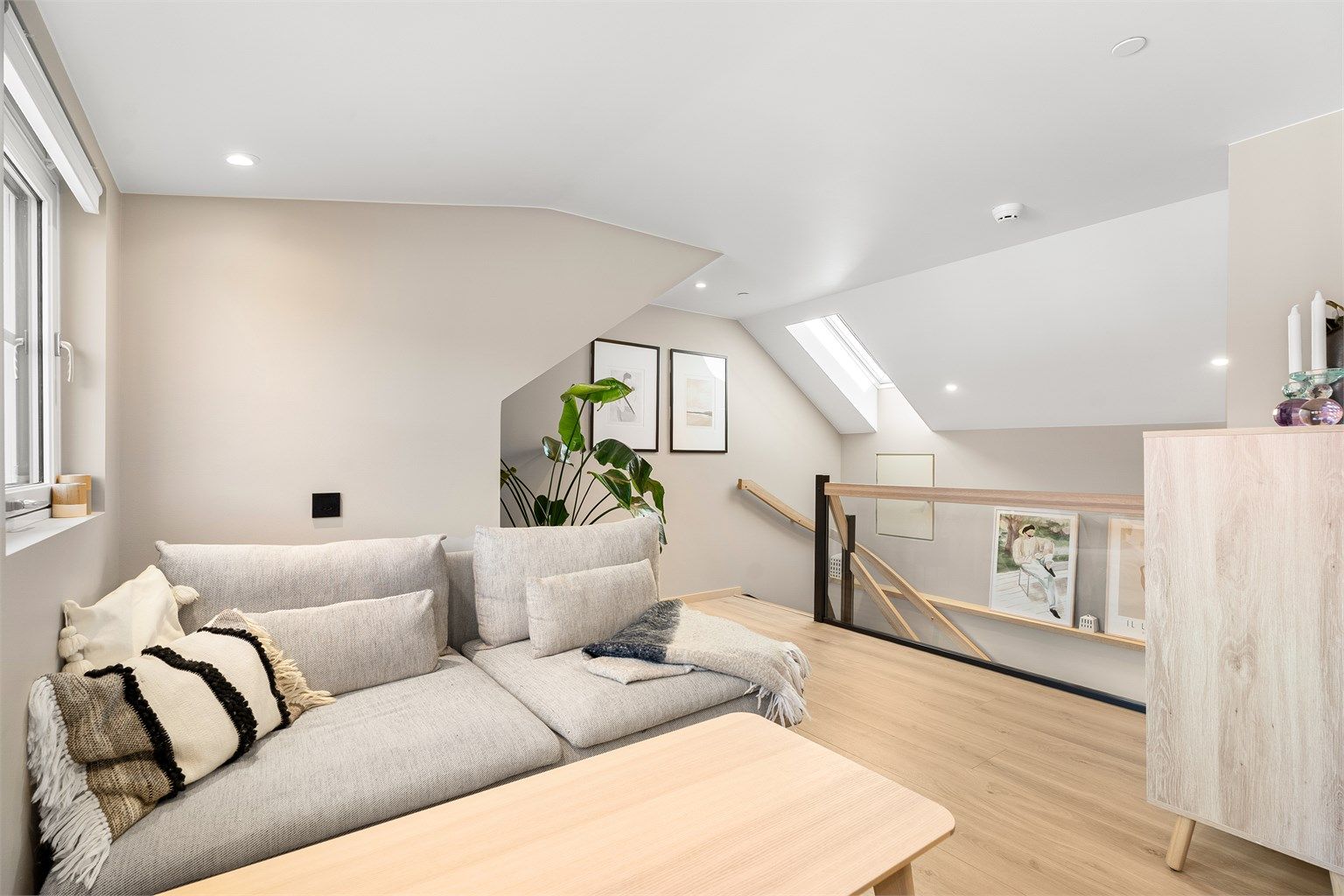 Loftsstue med plass til sofagruppe og tv-seksjon. Under vinduet til høyre i bildet er det også et kneloft med ekstra oppbevaringsplass. 