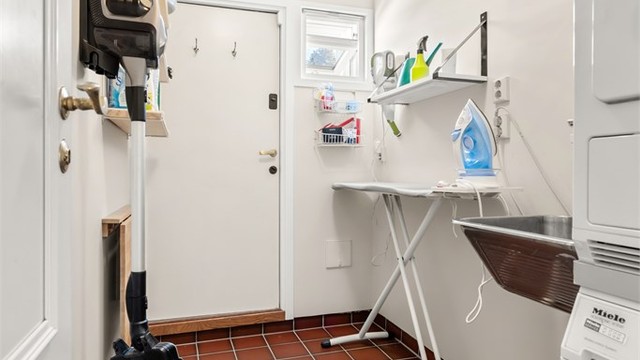 Eget praktisk vaskerom med direkte utgang til bakhagen med tørkestativ