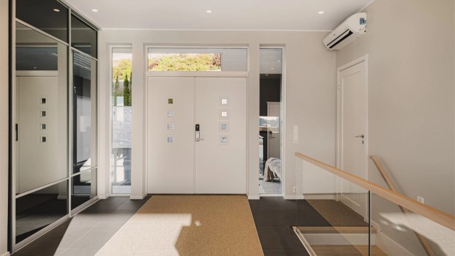 Velkommen inn i en lys og innbydende hall med god takhøyde, integrert garderobe og et gjennomført stilrent uttrykk.