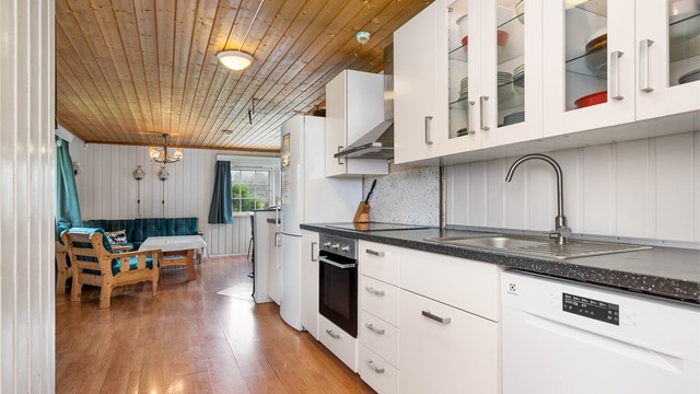 Kjøkkenet er utstyrt med frittstående oppvaskmaskin og kjøleskap.