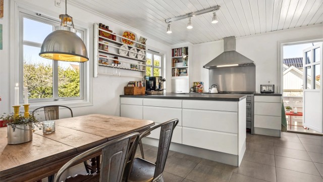 Kjøkkenet har en stilren JKE-innredning fra 2008, gulvvarme og utgang til en egen balkong.