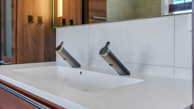 Dobbel servant med moderne, berøringsfrie armaturer.