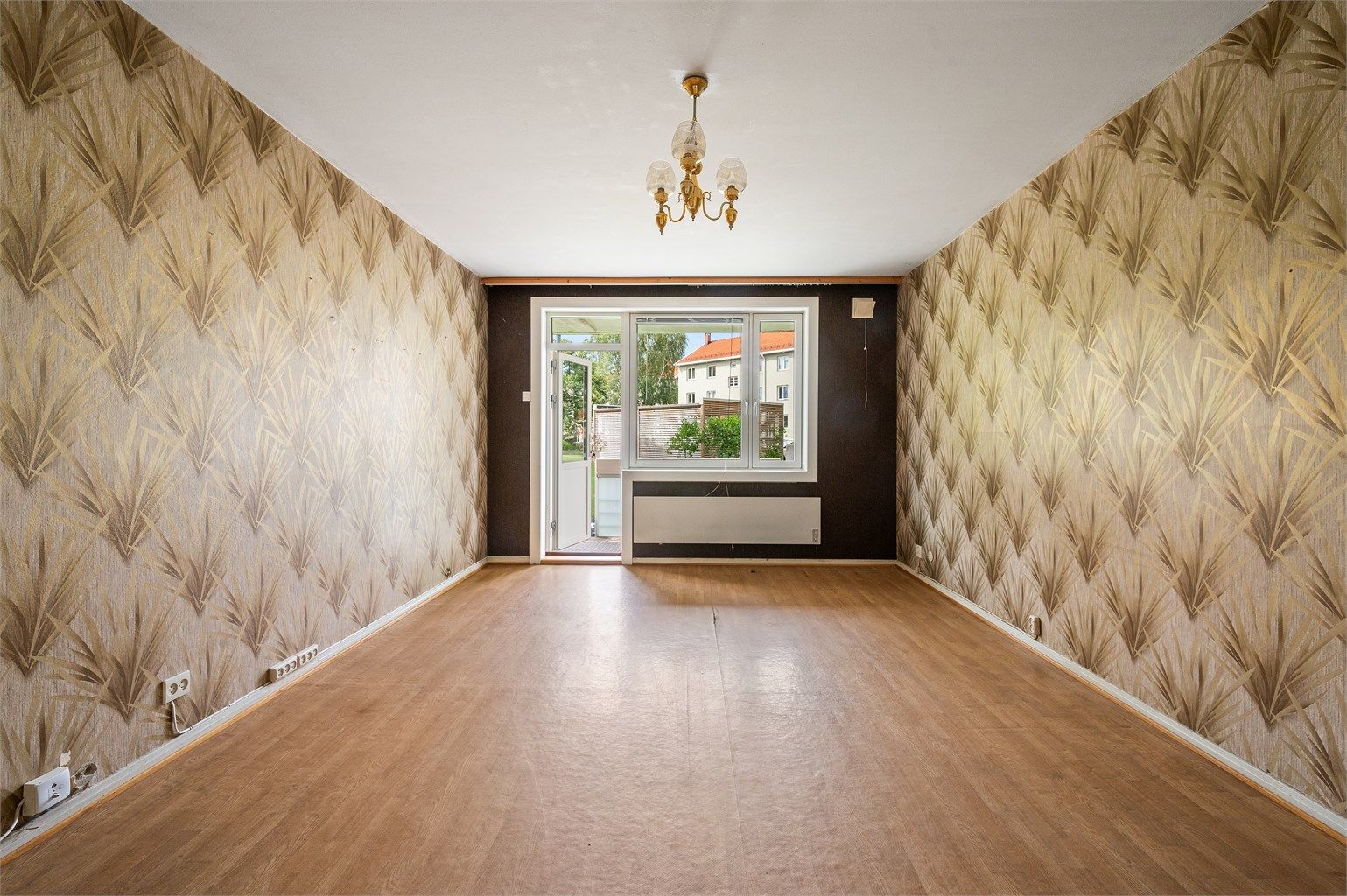 Stuen bærer tydelig preg av sin tid, med klassisk 60-tallstapet og original peis som minner om en svunnen æra