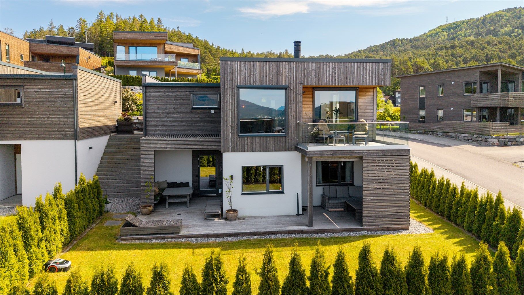 Stor hage og terrasse. Hekken gir en flott omramming av eiendommen 