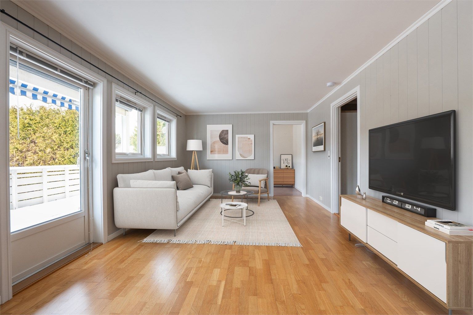 Leiligheten ble oppført i 2003 og har siden vært gjenstand for ulike moderniseringer. Flere rom er pusset opp, deriblant stuen hvor MDF-plater er montert på vegger. Bildet er digitalt møblert.