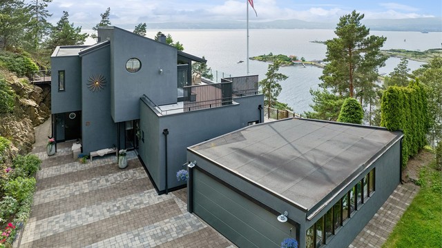 Pent opparbeidet tomt i skjønn forening med naturtomt. Brosteinslagt gårdsplass med god plass til parkering samt egen garasje.