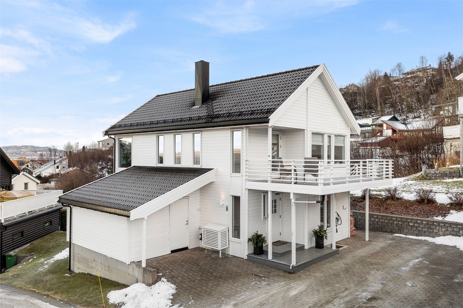 Boligen har flere biloppstillingsplasser i gårdsplassen. Elbil-lader ble installert i 2020 – godt tilpasset en moderne hverdag.