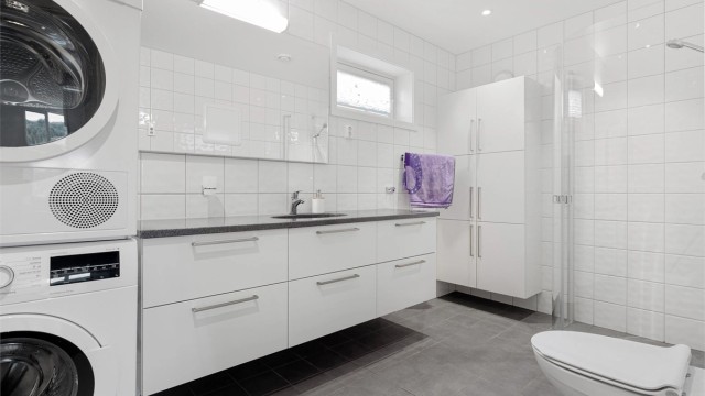 Stort flislagt bad på ca 6,5 kvm. med uttak for både vaskemaskin og tørketrommel.