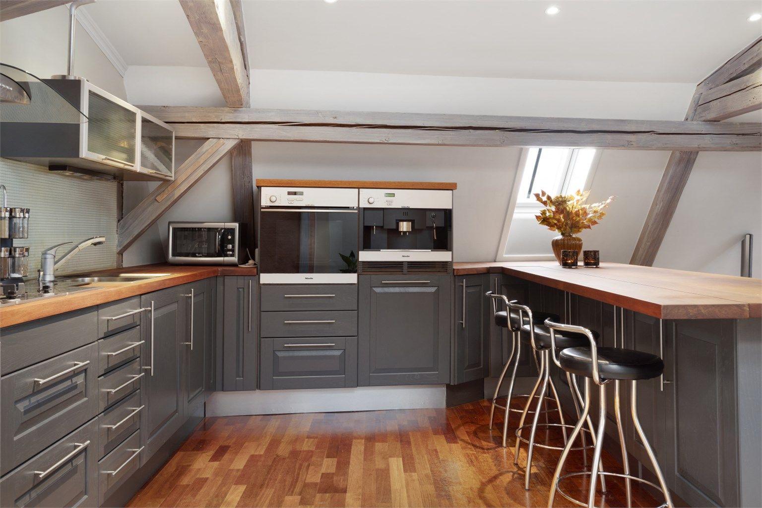 Kjøkkenet er innredet med integrert komfyr, kaffemaskin, oppvaskmaskin og koketopp. Frittstående kjøleskap medfølger ikke leiligheten.