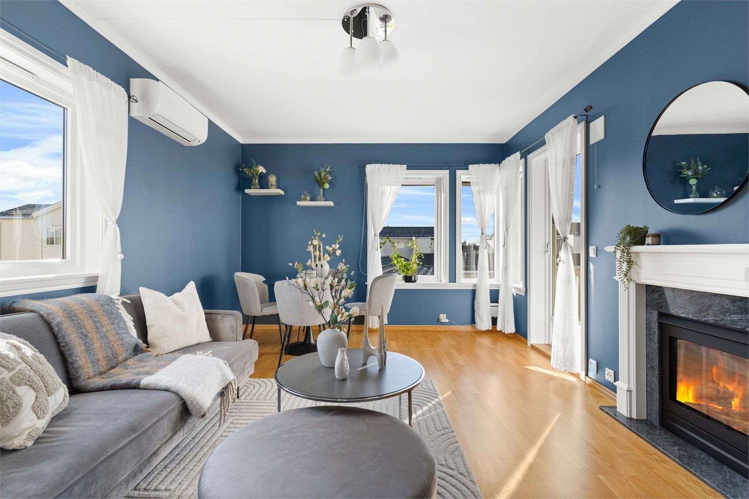 Leiligheten oppvarmes med varmepumpe og en stilren gasspeis som gir både varme og hygge. 