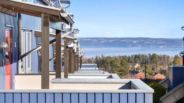 Inngangsparti med balkong og fjordutsikt.