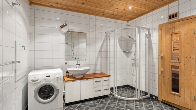 Baderommet har servantinnredning med ovenpåliggende servant og god benkeplass.