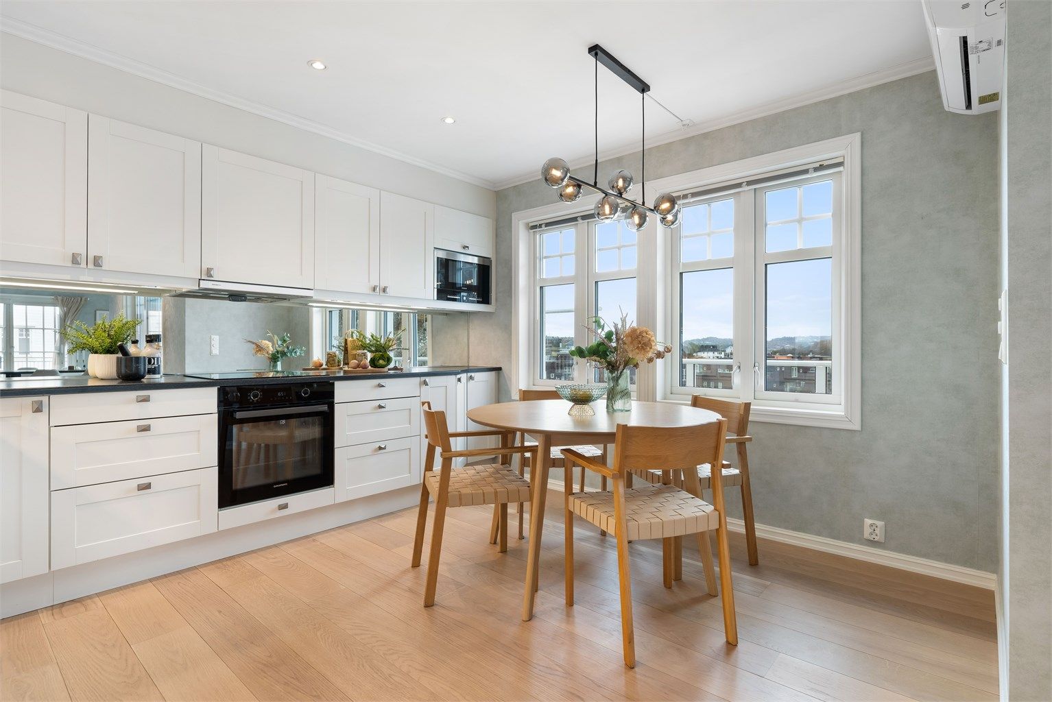 Koselig spiseplassen ved vinduet. Her der det montert varmepumpe på veggen til høyre