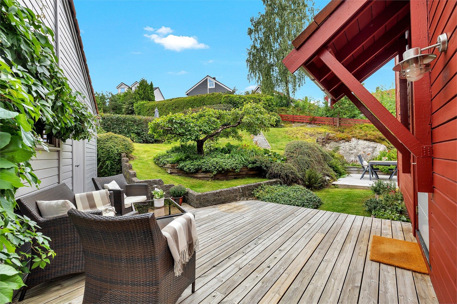 Hagen er gjennomtenkt utformet med gressplen, beplantning og dekorative nivåforskjeller som gir både dybde og karakter. Her får du en grønn og frodig ramme rundt uteområdet – et ideelt sted for avslapning, lek eller sosiale sammenkomster. 