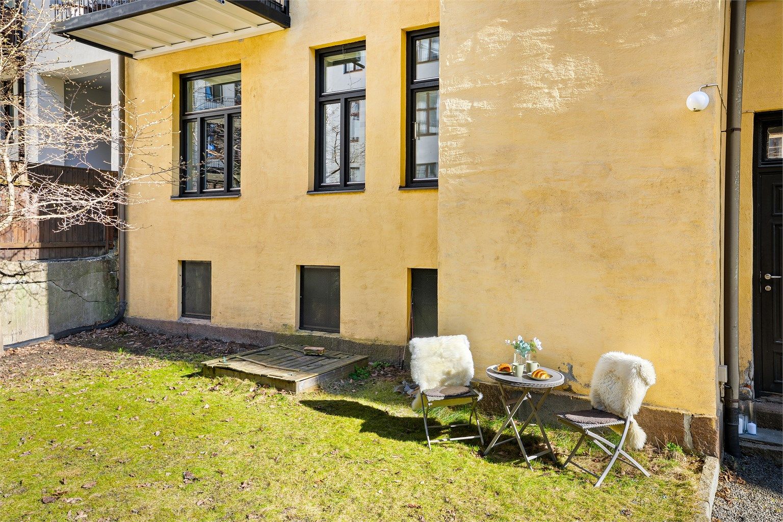 Nydelig bakgård med sitteplasser og grøntområdet felles for sameiet. Leiligheten ligger høyt til i 1.etasje mot bakgård.