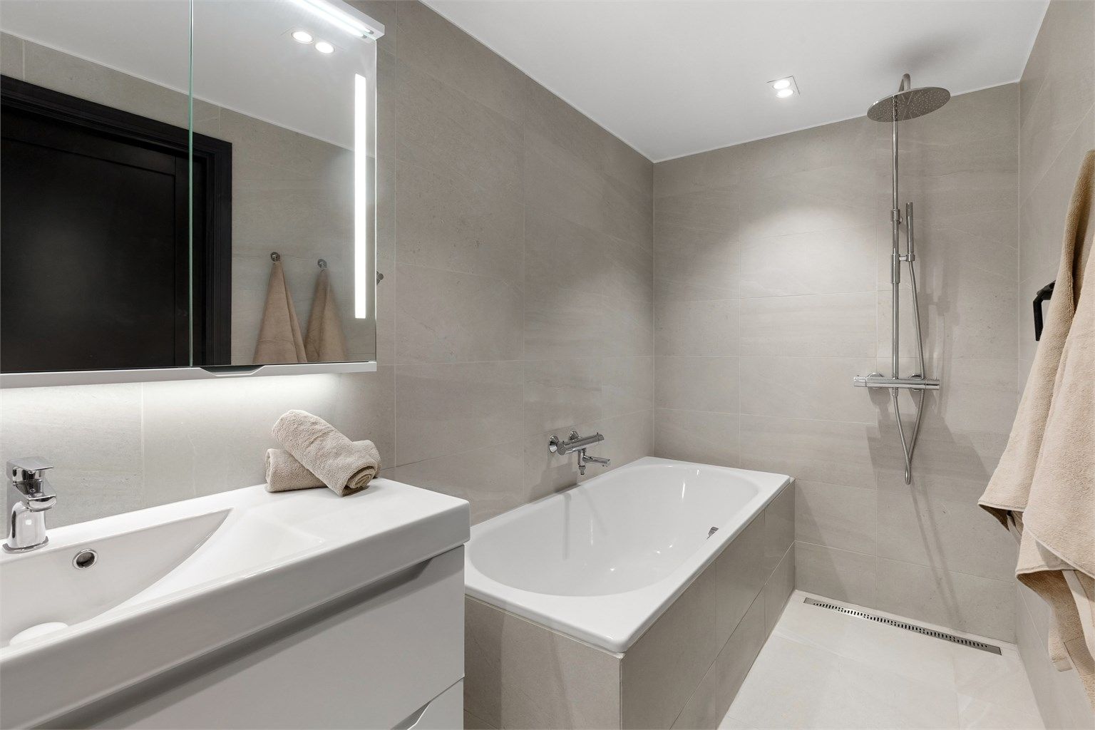 Moderne og flislagt baderom fra 2019 med gulvvarme, LED downlights i himling og regnfallsdusj