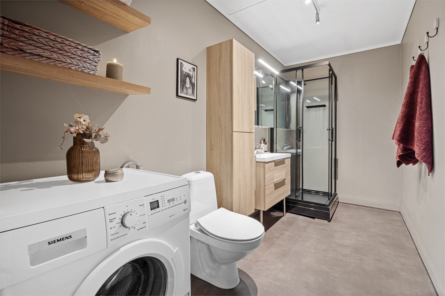 Bad med gulvbelegg og malte vegg- og himlingsflater. Opplegg for vaskemaskin.