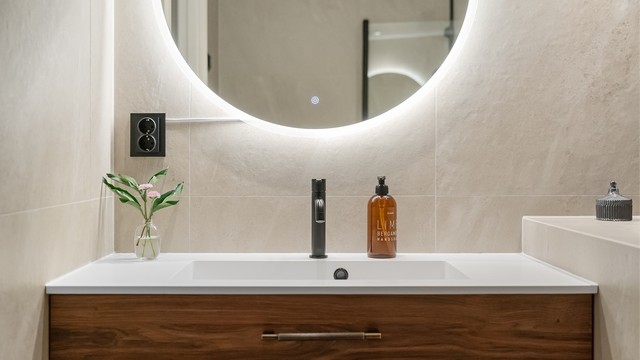 Moderne servantinnredning med speil med integrert belysning.