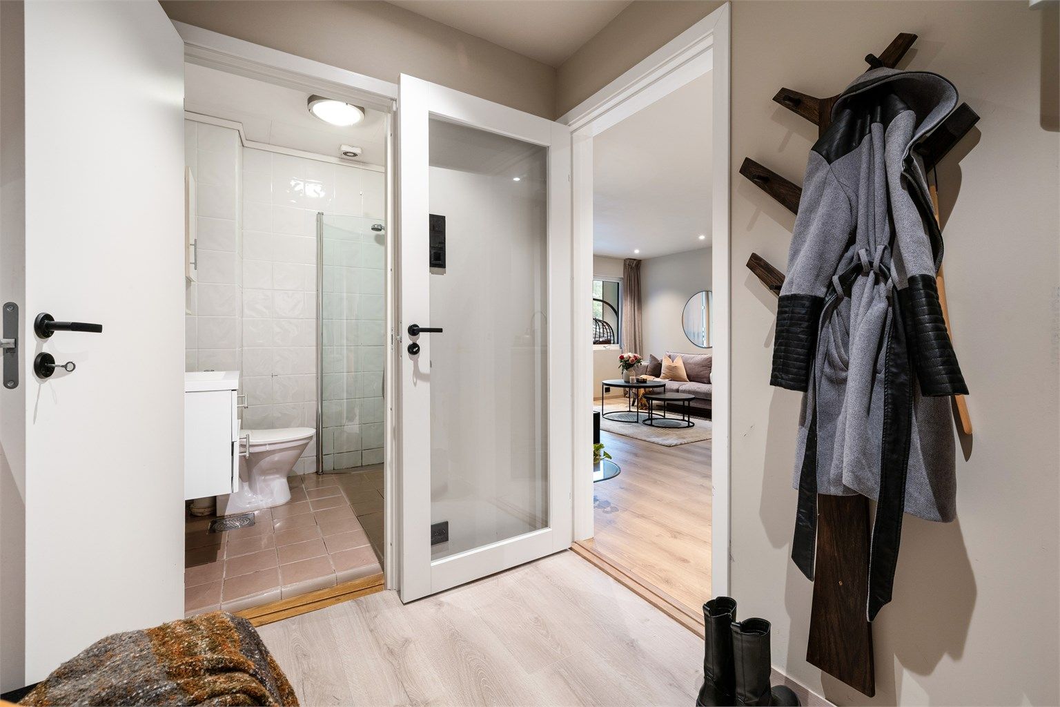 Velkommen inn! Leiligheten har en praktisk entré og dør med glassfelt inn mot stue for økt romfølelse. I entréen er det lagt lamiflex under laminatgulvet