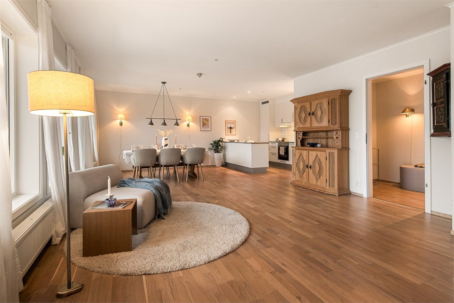 Åpen stue/kjøkkenløsning hvor kjøkkenet er noe tilbaketrukket og således fint skjermet