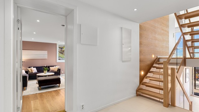 Fra entré er det en halvtrapp opp til tv-stuen/ungdomsstuen. Det er egen inngang til gangen fra baksiden av huset.