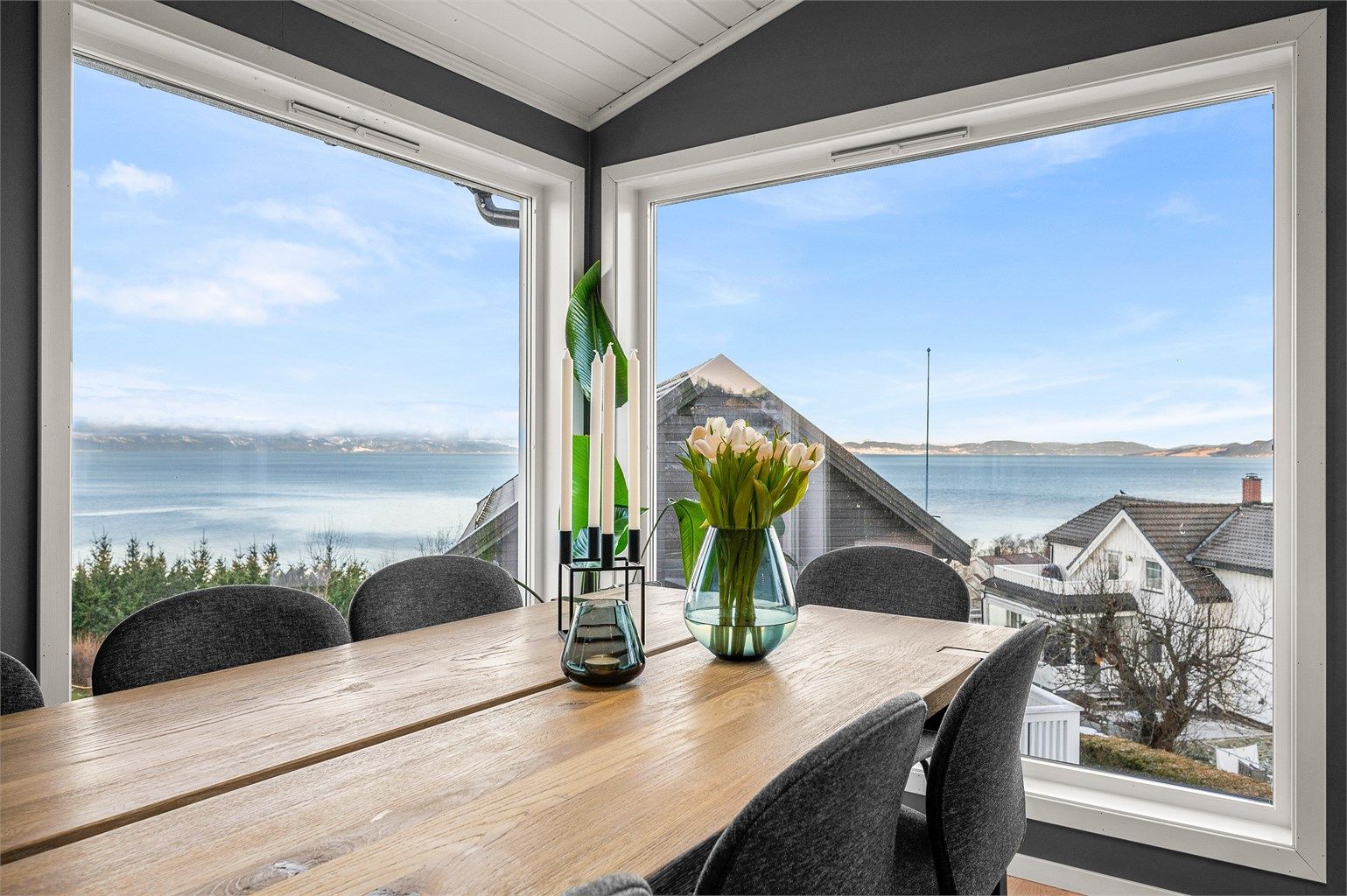 Lys og romslig spiseplass med store vindusflater som slipper inn rikelig med dagslys og gir flott utsyn mot fjorden.