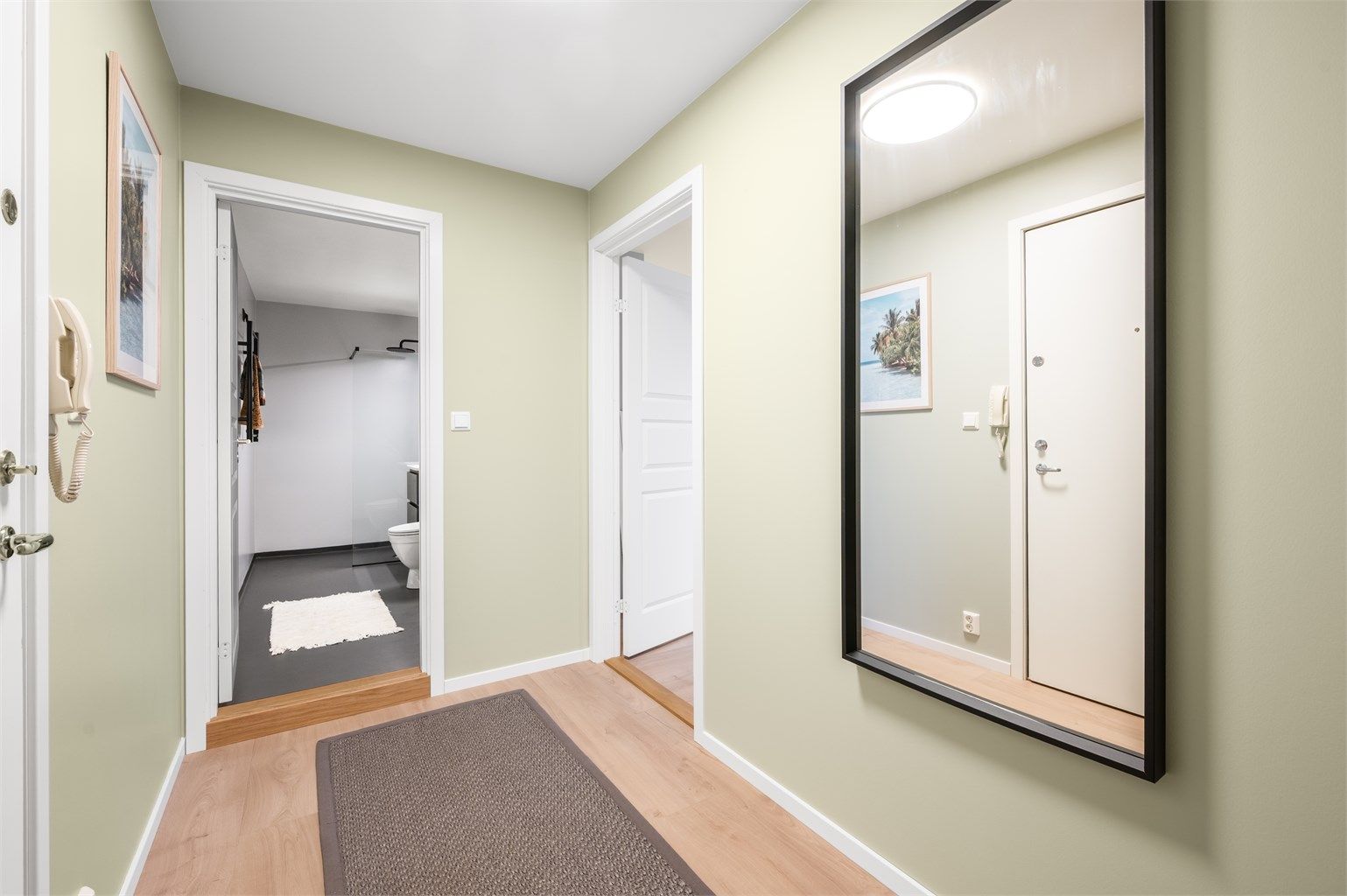 Entréen har laminat på gulv og overflateoppussede flater fra 2025 i delikate og tidløse fargetoner, som gir et gjennomgående og helhetlig førsteinntrykk.