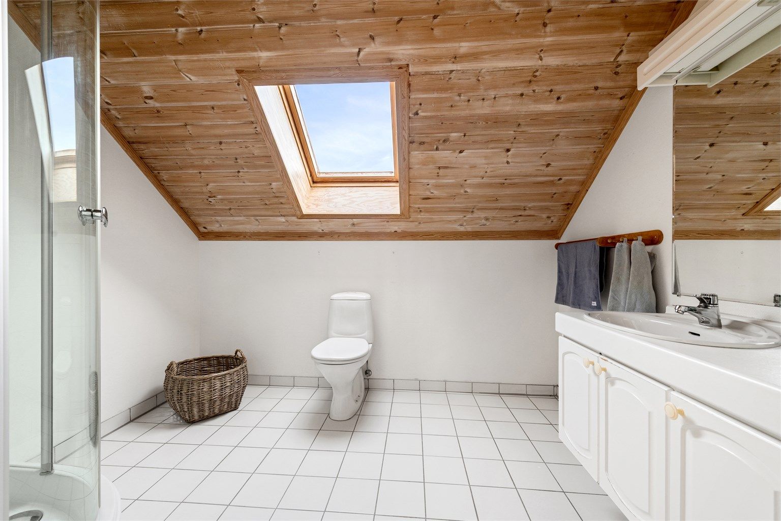 Badet i 2. etasje har profilert hvit baderomsinnredning, toalett og dusjkabinett