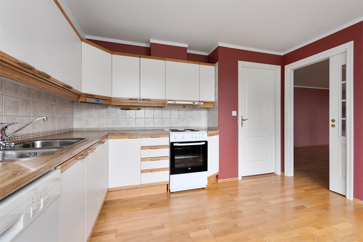 Fra kjøkkenet er det dør til vaskerom, samt skyvedør med glassfelt mot stue. 