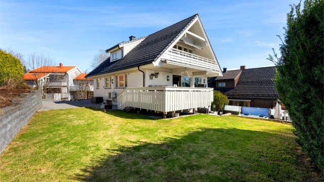 Hagen er pent opparbeidet med plenarealer og diverse beplantning.