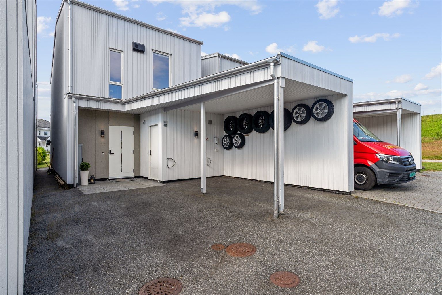 Stort gårdsrom og carport med elbil lader.