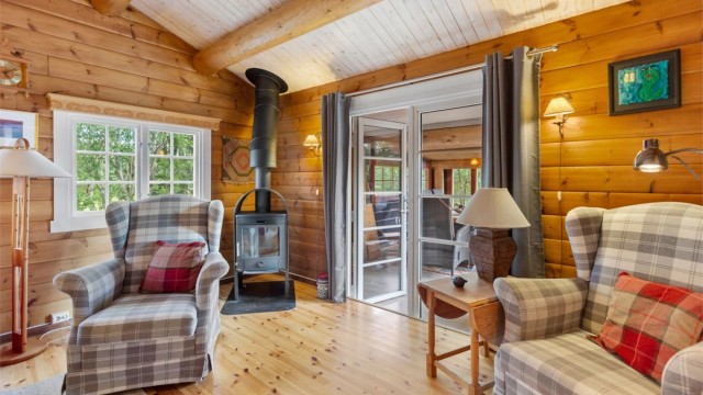 Krogsveen Sunnmøre v/Harald Osdal har gleden av å presentere en unik og innholdsrik fritidsbolig - bildet tatt innenfra stuen, med de doble dørene slått åpne ut mot den møblerte utestuen
Foto: Jarle Osen