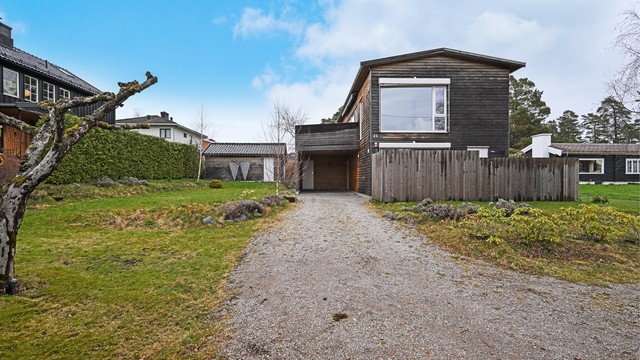 Tomten er opparbeidet med plen og gruset innkjørsel.