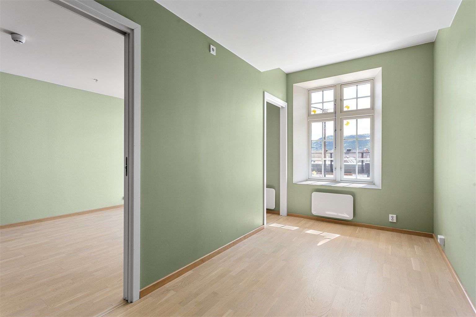 Leiligheten har et romslig soverom, plassert ved siden av stuen.