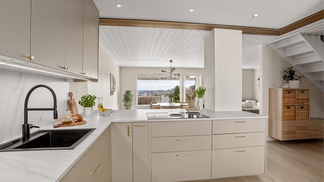 Kjøkkenet ligget i en åpen løsning til stuen og tilbyr rikelig med både skap- og benkeplass