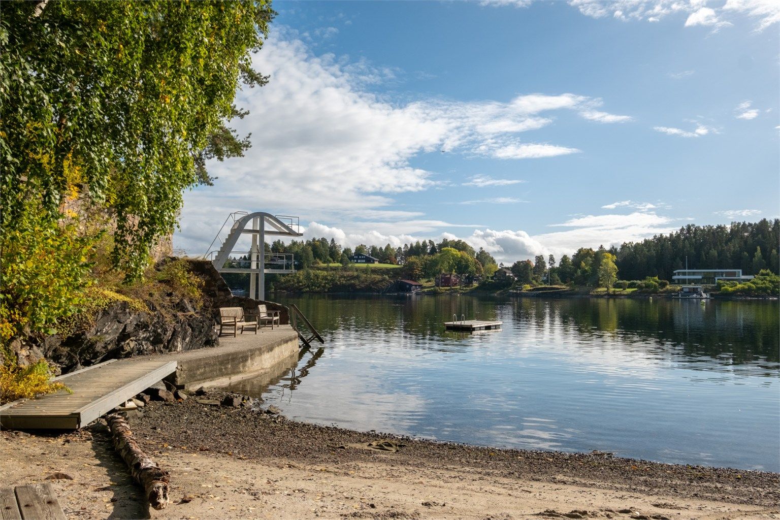 Badeplass med stupetårn og strand ved fjorden like i nærheten